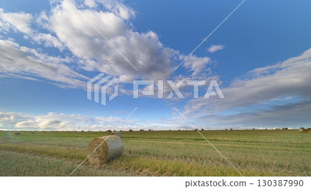 A breathtaking scenic landscape featuring hay bales beautifully situated under a bright blue sky A breathtaking scenic landscape featuring hay bales beautifully situated under a bright blue sky 130387990