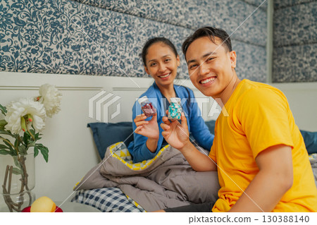 Joyful Moments: A Mother and Son Sharing Treats in a Cozy Home Setting Joyful Moments: A Mother and Son Sharing Treats in a Cozy Home Setting 130388140