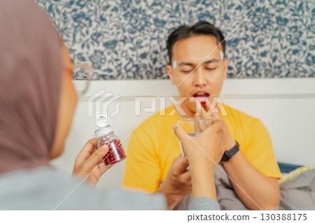 A Couple Sharing Health Supplements Together in Their Comfortable, Cozy Home A Couple Sharing Health Supplements Together in Their Comfortable, Cozy Home 130388175