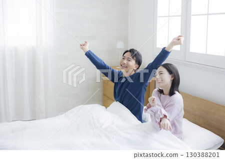 Couple relaxing in bed Couple relaxing in bed 130388201