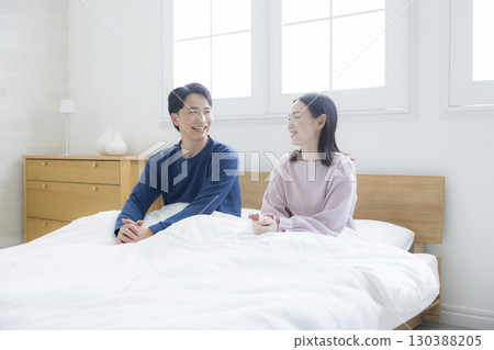 Couple relaxing in bed Couple relaxing in bed 130388205
