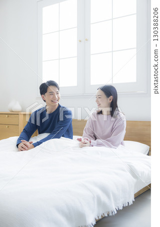 Couple relaxing in bed Couple relaxing in bed 130388206