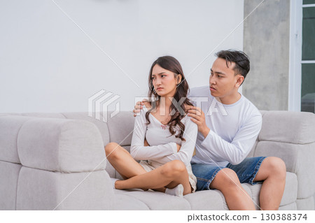 A Couple in Conflict Engaging in an Emotional Conversation While Seated on a Sofa 130388374