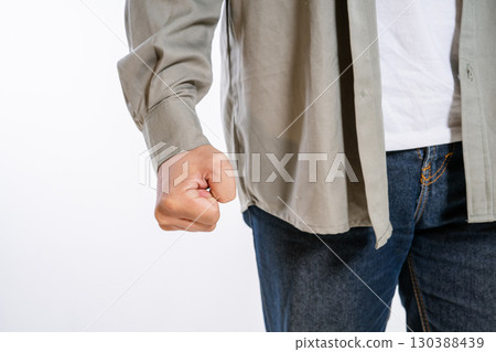 A clenched fist symbolizes anger and determination, shown even in casual attire A clenched fist symbolizes anger and determination, shown even in casual attire 130388439