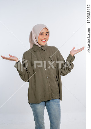 Cheerful Young Woman Dressed in Casual Outfit with Open Hands, Smiling Brightly 130388482