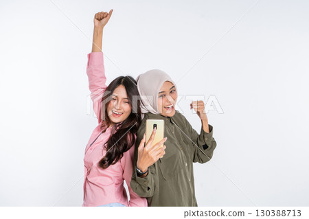 A Group of Joyful Friends Celebrating Together by Taking a Fun Smartphone Selfie 130388713