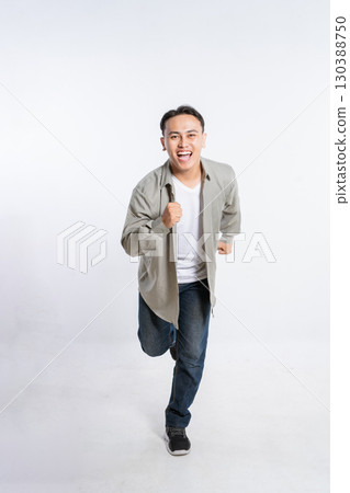 A Vibrant and Energetic Young Man Joyfully Running in a Modern Urban Setting A Vibrant and Energetic Young Man Joyfully Running in a Modern Urban Setting 130388750
