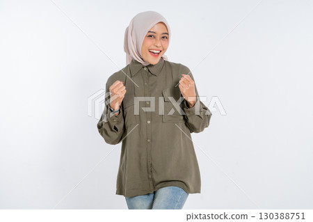 Joyful Young Woman in Casual Outfit with Hijab against White Background Joyful Young Woman in Casual Outfit with Hijab against White Background 130388751