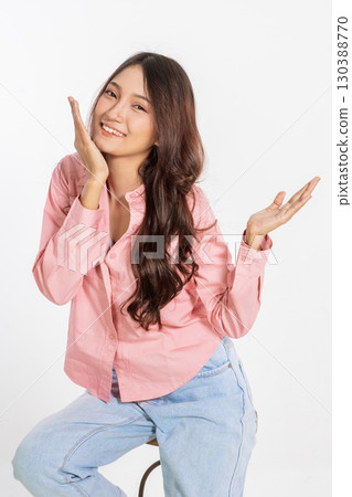 Cheerful Young Woman Posing Playfully and Joyfully Against a Pure White Background Cheerful Young Woman Posing Playfully and Joyfully Against a Pure White Background 130388770