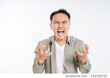 Furious Young Man Expressing Anger and Frustration on White Background 130388793