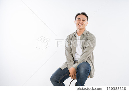 Young Man with a Lovely Smile Wearing a Casual Outfit Against a White Background Young Man with a Lovely Smile Wearing a Casual Outfit Against a White Background 130388818