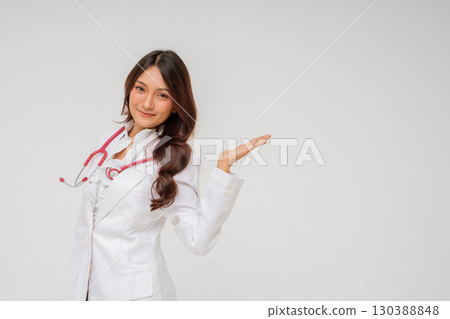 A Smiling Female Doctor Holding a Stethoscope and Presenting Various Healthcare Services A Smiling Female Doctor Holding a Stethoscope and Presenting Various Healthcare Services 130388848