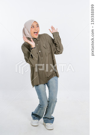 A Cheerful Young Woman Dressed in a Casual Outfit Joyfully Expressing Her Happiness 130388899