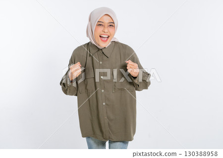 Joyful Young Woman Celebrating Her Success While Wearing a Casual Outfit 130388958