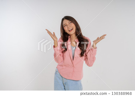 Joyful Young Woman Dressed in a Pink Blazer Making a Fun and Playful Gesture Joyful Young Woman Dressed in a Pink Blazer Making a Fun and Playful Gesture 130388968