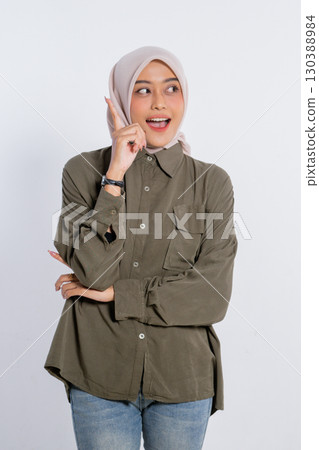 A Young Woman Sporting a Casual Outfit while Displaying a Delightful Gesture A Young Woman Sporting a Casual Outfit while Displaying a Delightful Gesture 130388984