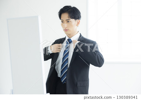 young man wearing a suit 130389341