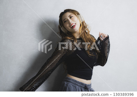 A woman listening to music 130389396