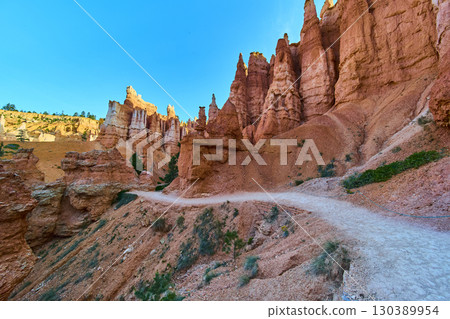 Bryce Canyon Hoodoos and Winding Trail Under Bright Blue Sky Utah Landscape 130389954