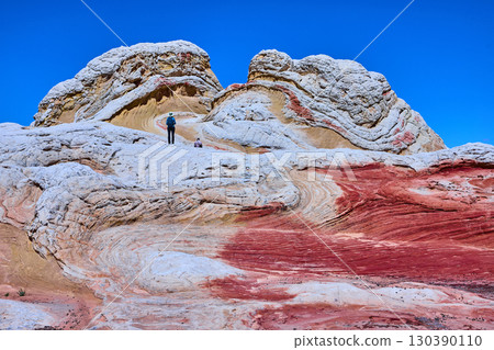 White Pocket Sandstone Formations with Hikers and Blue Sky Arizona Low Angle 130390110
