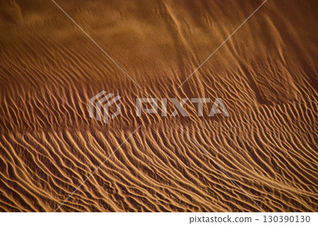Sand Dune Ripples and Wind Sculpted Texture with Aerial Fly Over Perspective Sand Dune Ripples and Wind Sculpted Texture with Aerial Fly Over Perspective 130390130