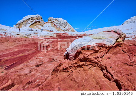 Vermilion Cliffs sandstone formations with hikers under blue sky Marble Canyon 130390146