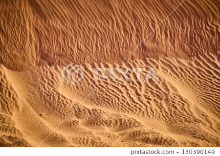 Wind Sculpted Desert Sand Dune Patterns and Ripples Golden Hour Abstract Overhead Wind Sculpted Desert Sand Dune Patterns and Ripples Golden Hour Abstract Overhead 130390149