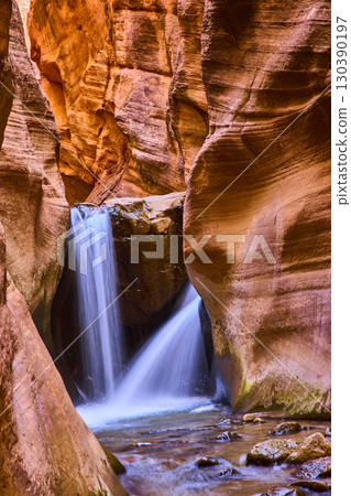 Kanarra Falls Waterfall Motion in Red Sandstone Slot Canyon Vertical Perspective 130390197