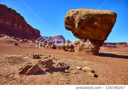 Balanced Rock Formation with Red Cliffs and Desert Terrain Eye Level View 130390267