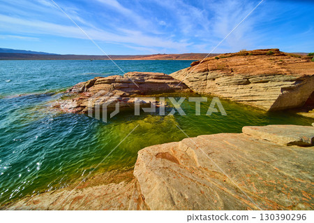 Red Sandstone Rocks and Clear Lake Waters with Desert Horizon Eye Level Red Sandstone Rocks and Clear Lake Waters with Desert Horizon Eye Level 130390296