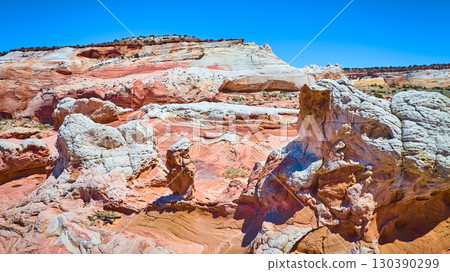 Aerial Fly Through Swirling Sandstone Layers White Pocket Spires and Natural Arch Aerial Fly Through Swirling Sandstone Layers White Pocket Spires and Natural Arch 130390299
