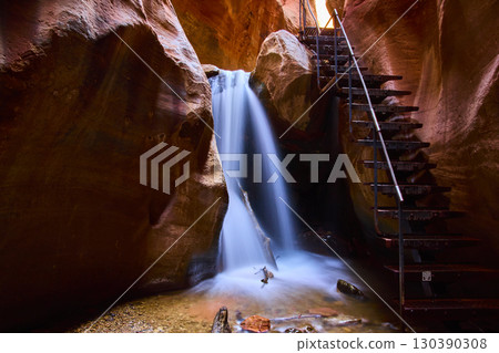 Kanarra Falls Waterfall with Steel Ladder and Sandstone Canyon Walls Low Angle Kanarra Falls Waterfall with Steel Ladder and Sandstone Canyon Walls Low Angle 130390308