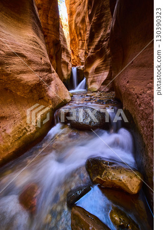 Kanarra Falls Waterfall Flowing Through Red Slot Canyon Upstream Perspective Kanarra Falls Waterfall Flowing Through Red Slot Canyon Upstream Perspective 130390323