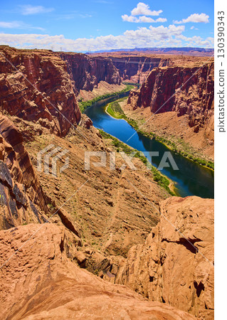 Colorado River Winding Through Red Rock Canyon Vertical Cliffside Perspective 130390343