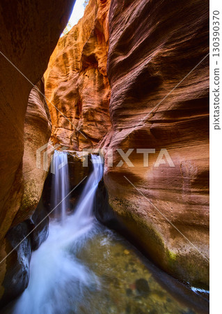 Waterfall Motion Through Sandstone Slot Canyon with Pool Eye Level Perspective Waterfall Motion Through Sandstone Slot Canyon with Pool Eye Level Perspective 130390370