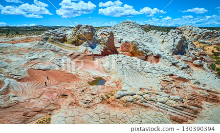 Aerial White Pocket Sandstone Formations with Hikers and Dramatic Sky Fly Over Aerial White Pocket Sandstone Formations with Hikers and Dramatic Sky Fly Over 130390394