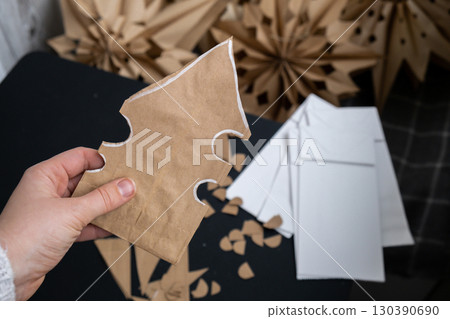 Master class of making craft paper snowflakes for conscientious Christmas decor. Sustainable celebration minimal responsible DIY holiday project. Step by step Master class of making craft paper snowflakes for conscientious Christmas decor. Sustainable celebration minimal responsible DIY holiday project. Step by step 130390690