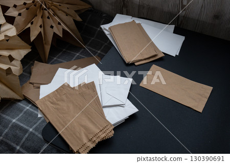 Sustainableminded Christmas cozy home handmade decoration. Tutorial for making do it yourself craft paper lunch bags and hot glue. Seasonal activity for kids. 3D snowflakes eve preparation 130390691