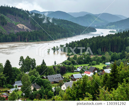 AI generated contrast of deforested mountain with flooded village and lush forest with peaceful homes under heavy rain 130391292