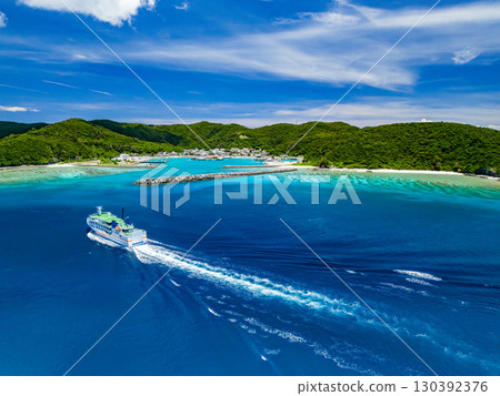 Drone shot of Agena Shiki Island. A large ferry enters Zamami Port. Zamami Island, Kerama Islands, Shimajiri District, Okinawa Prefecture - 2025 Drone shot of Agena Shiki Island. A large ferry enters Zamami Port. Zamami Island, Kerama Islands, Shimajiri District, Okinawa Prefecture - 2025 130392376