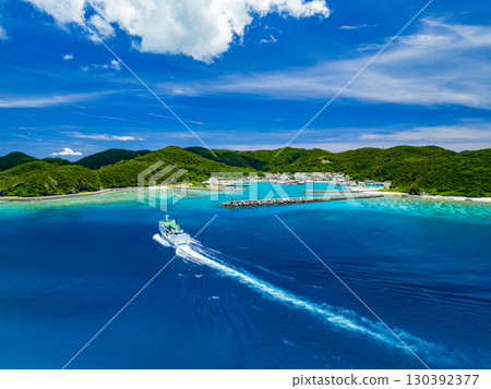 Drone shot of Agena Shiki Island. A large ferry enters Zamami Port. Zamami Island, Kerama Islands, Shimajiri District, Okinawa Prefecture - 2025 Drone shot of Agena Shiki Island. A large ferry enters Zamami Port. Zamami Island, Kerama Islands, Shimajiri District, Okinawa Prefecture - 2025 130392377