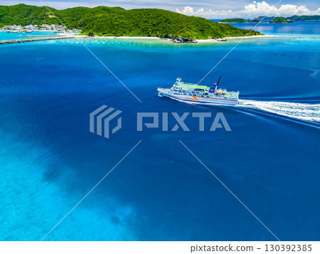 Drone shot of Agena Shiki Island. A large ferry enters Zamami Port. Zamami Island, Kerama Islands, Shimajiri District, Okinawa Prefecture - 2025 Drone shot of Agena Shiki Island. A large ferry enters Zamami Port. Zamami Island, Kerama Islands, Shimajiri District, Okinawa Prefecture - 2025 130392385