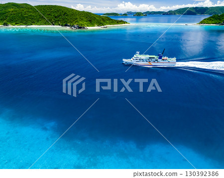 Drone shot of Agena Shiki Island. A large ferry enters Zamami Port. Zamami Island, Kerama Islands, Shimajiri District, Okinawa Prefecture - 2025 Drone shot of Agena Shiki Island. A large ferry enters Zamami Port. Zamami Island, Kerama Islands, Shimajiri District, Okinawa Prefecture - 2025 130392386
