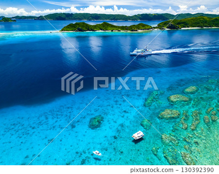 Drone shot of Agena Shiki Island. A large ferry enters Zamami Port. Zamami Island, Kerama Islands, Shimajiri District, Okinawa Prefecture - 2025 130392390