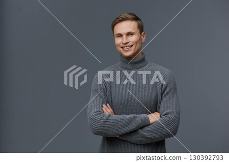 smiling young caucasian man with grey sweater crossed arms digital detox concept isolated on grey background studio portrait smiling young caucasian man with grey sweater crossed arms digital detox concept isolated on grey background studio portrait 130392793