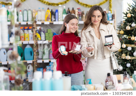 On New Year Eve, woman with teen daughter choose cosmetic pallet for allergy sufferers On New Year Eve, woman with teen daughter choose cosmetic pallet for allergy sufferers 130394195