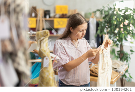 Teenage girl at a clothes sale 130394261