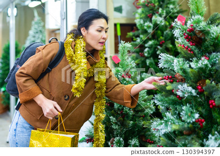 Woman purchasing christmas tree 130394397
