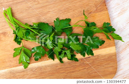 Fresh parsley aromatic herbs on kitchen table Fresh parsley aromatic herbs on kitchen table 130394477