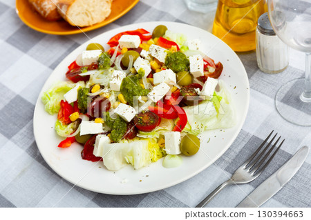 Portion of fresh salad served on table 130394663